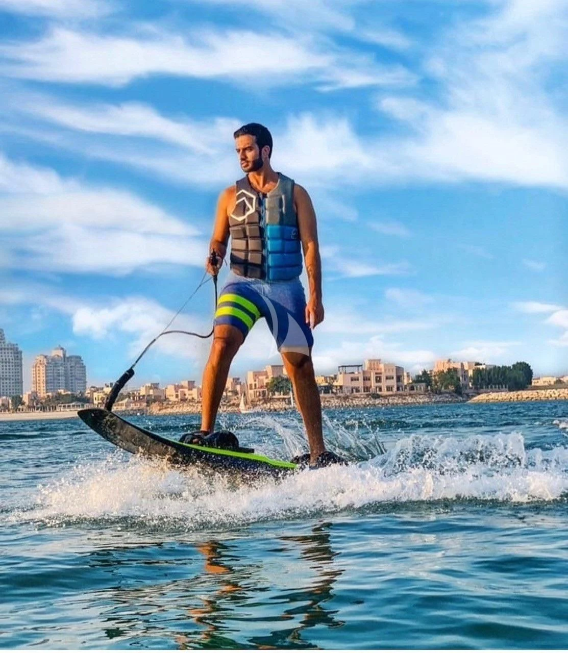 a man on a surfboard aboard CYNDERELLA Yacht for Sale