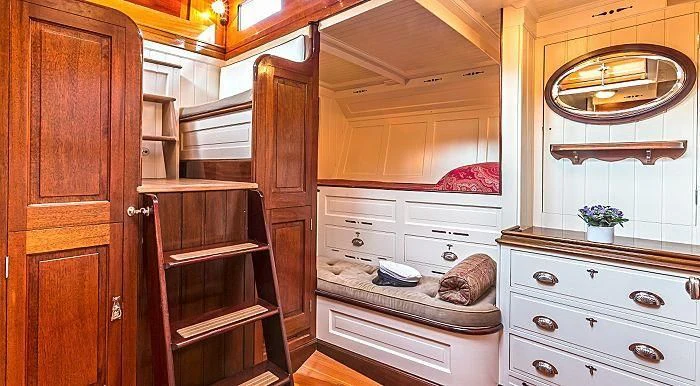 a room with a dresser and a mirror aboard MARIQUITA Yacht for Sale