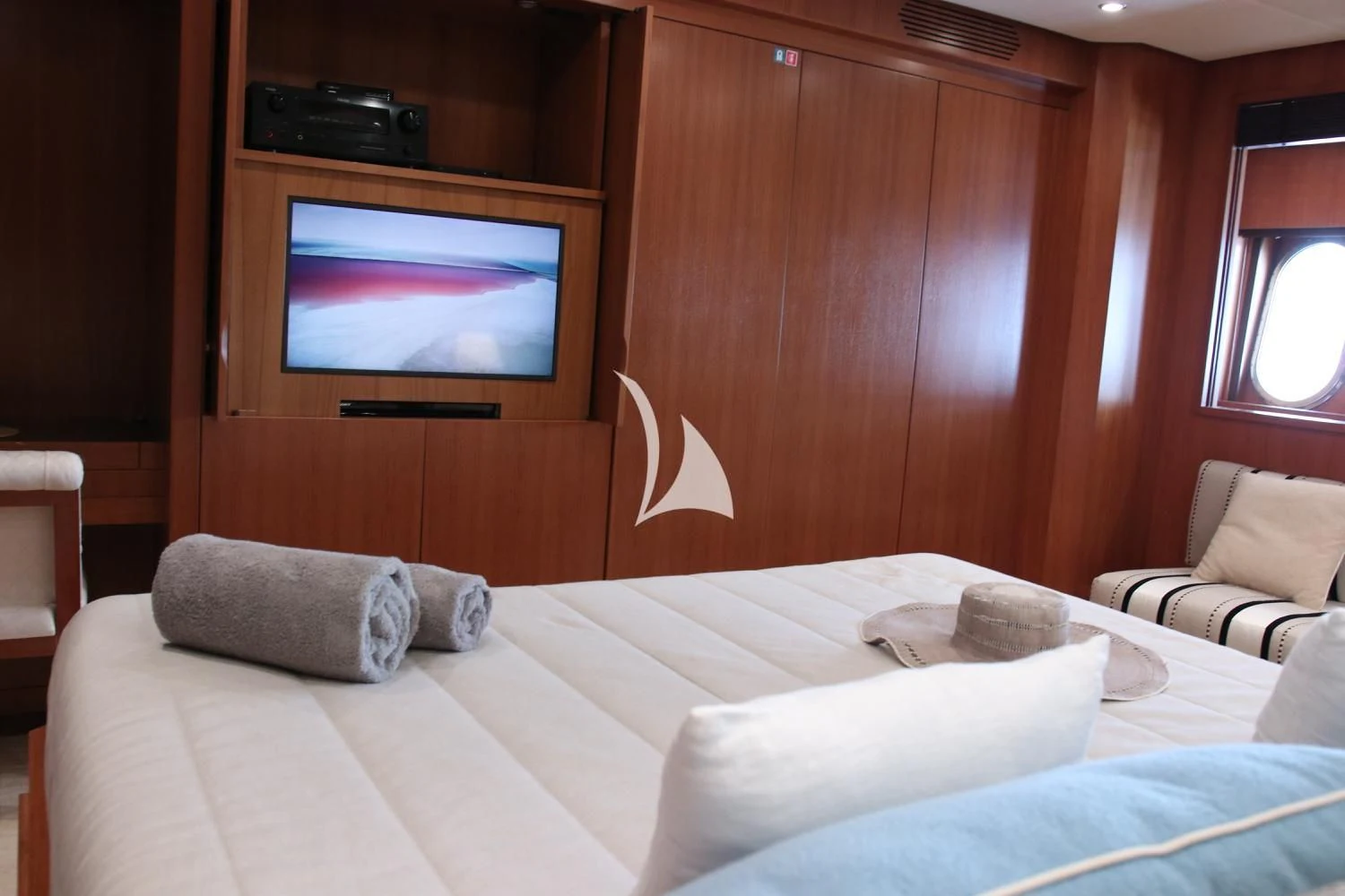 a room with a bed and a television aboard RAMSES II Yacht for Sale