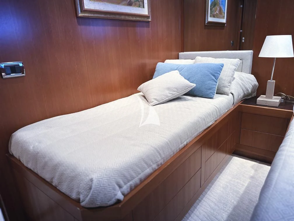 a bed with a white comforter aboard RAMSES II Yacht for Sale