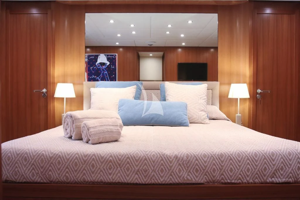 a bed with a white comforter aboard RAMSES II Yacht for Sale