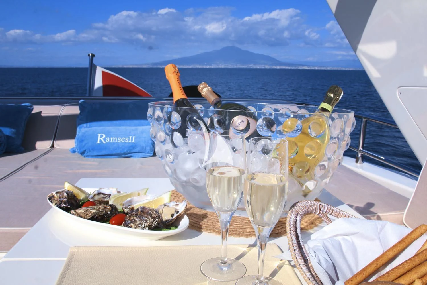 a table with food and drinks on it aboard RAMSES II Yacht for Sale