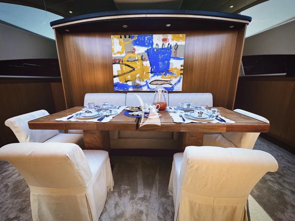 a table with chairs and a large screen aboard RAMSES II Yacht for Sale