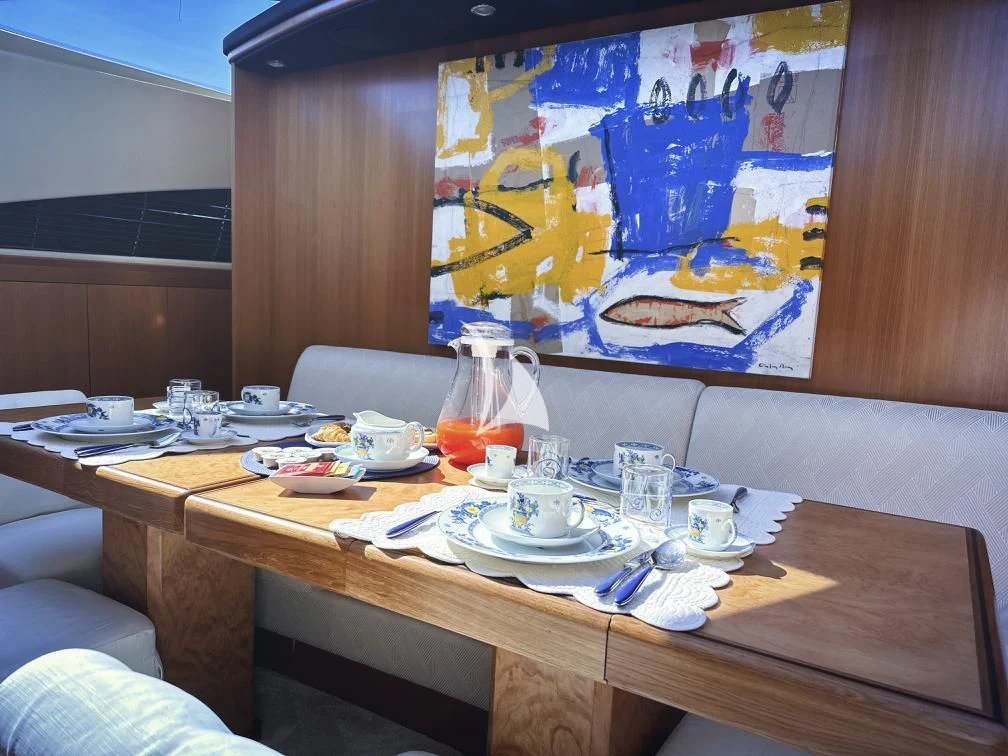 a table with plates and cups on it aboard RAMSES II Yacht for Sale