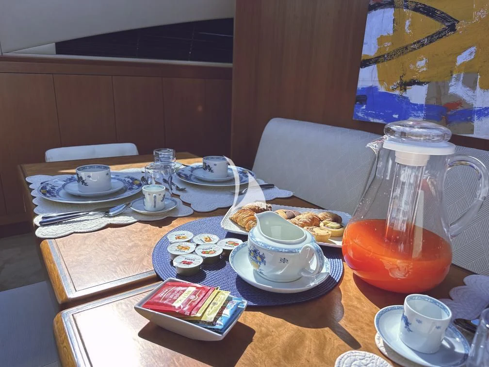a table with plates and cups on it aboard RAMSES II Yacht for Sale