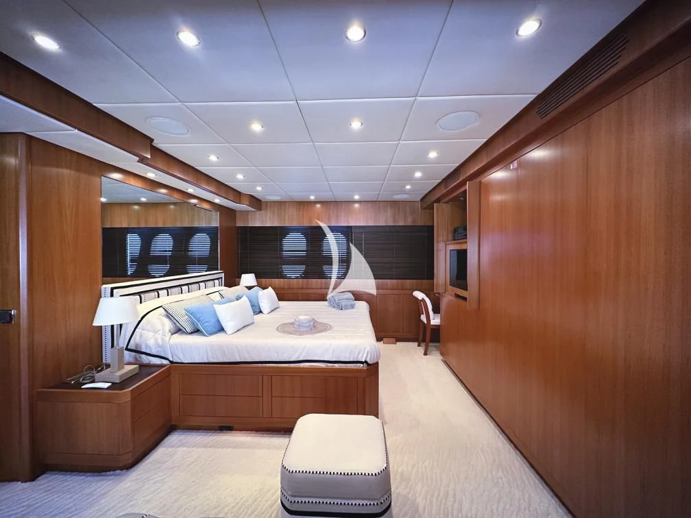 a bedroom with a bed and a desk aboard RAMSES II Yacht for Sale
