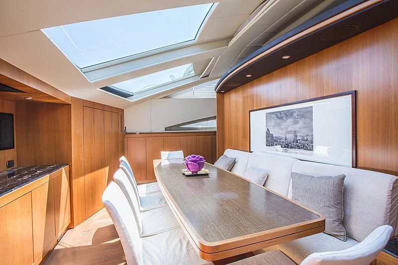 a room with a table and chairs aboard RAMSES II Yacht for Sale