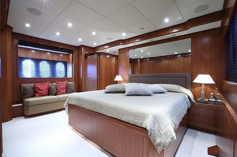 a large bedroom with a bed and a couch aboard RAMSES II Yacht for Sale