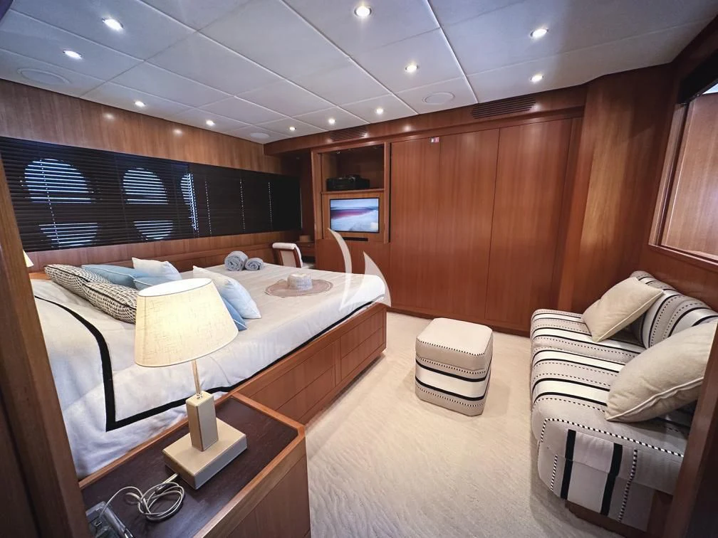 a room with a bed and a television aboard RAMSES II Yacht for Sale