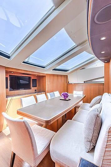 a living room with a table and chairs aboard RAMSES II Yacht for Sale