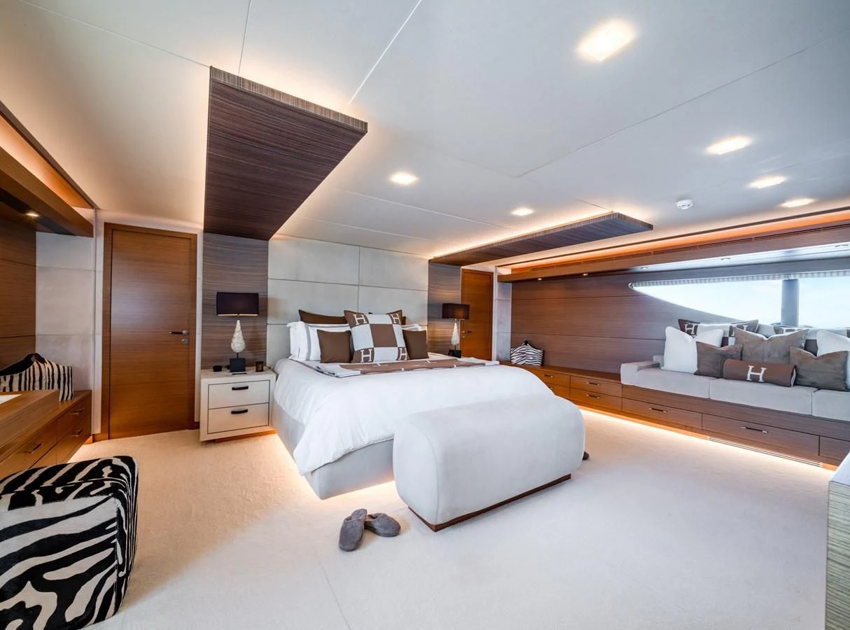 a room with a bed and a couch aboard QHT Yacht for Sale