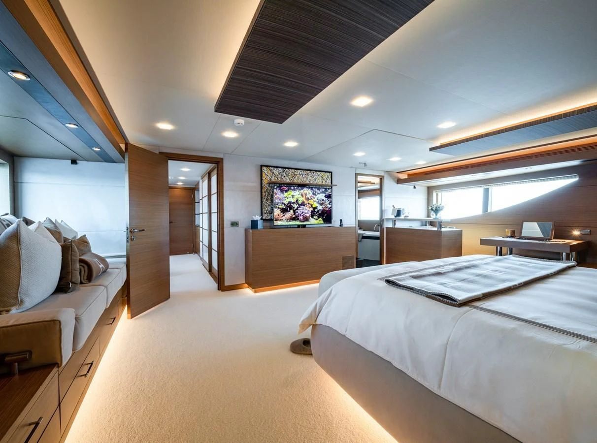 a room with a bed and a television aboard QHT Yacht for Sale