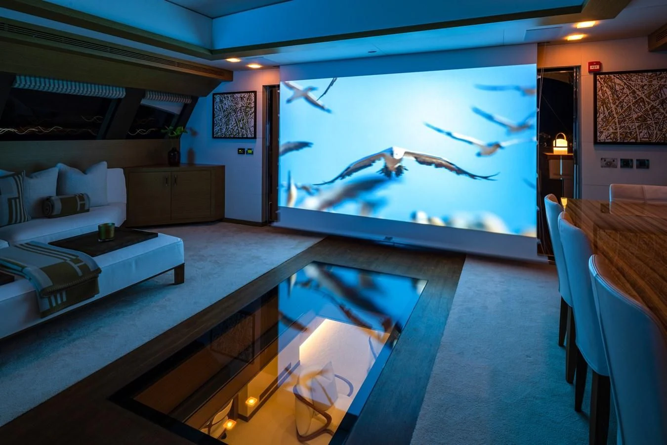 a room with a large screen aboard QHT Yacht for Sale