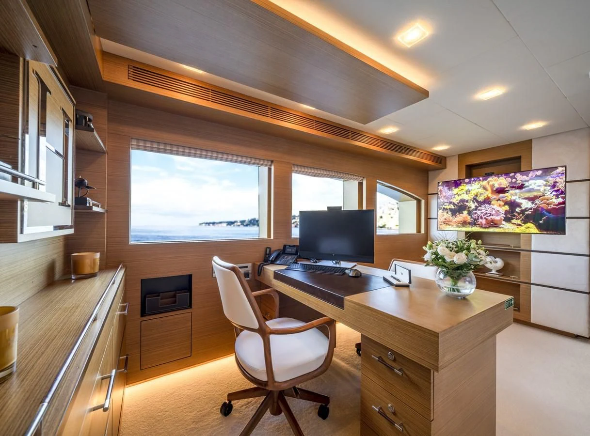 a kitchen with a desk and a tv aboard QHT Yacht for Sale