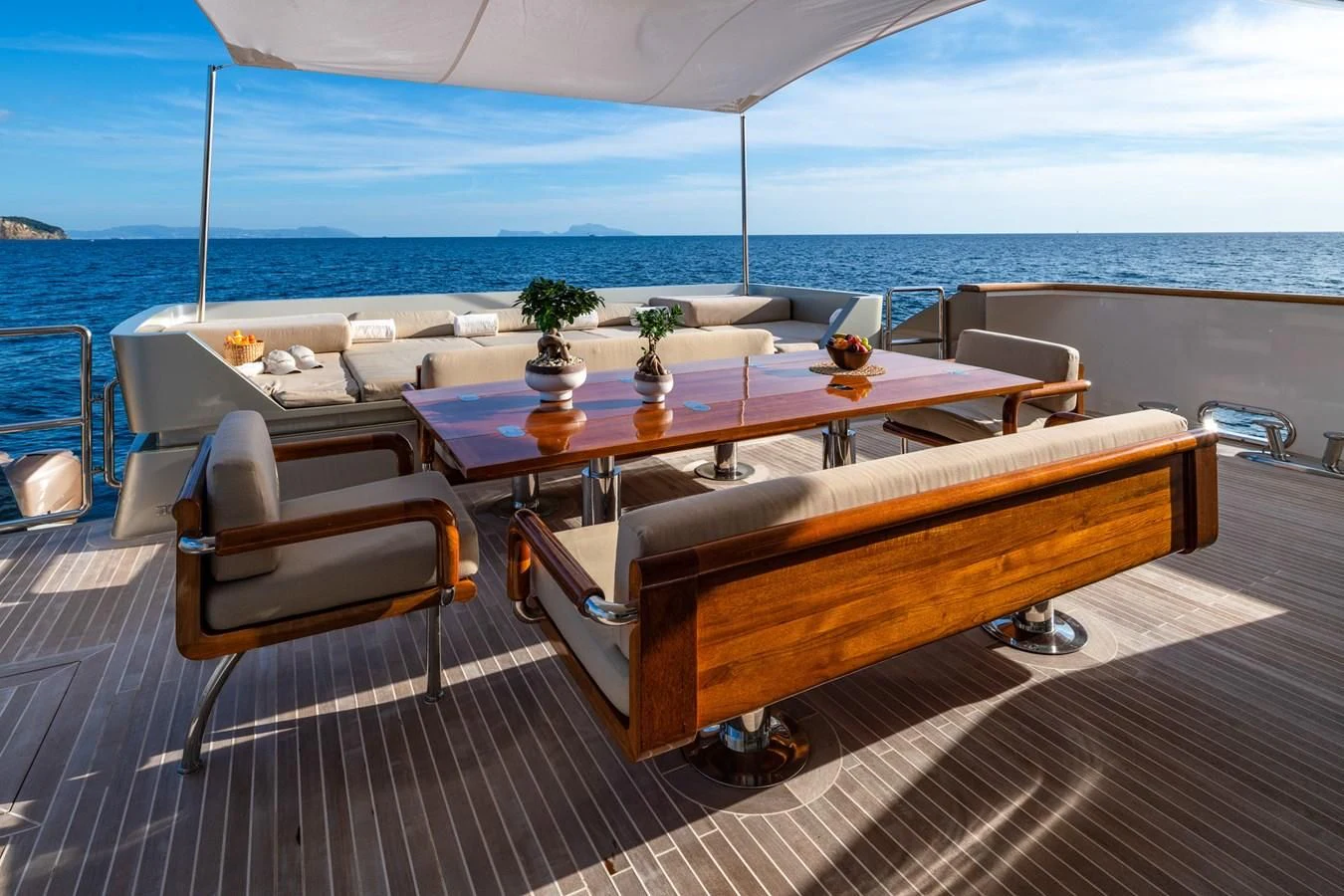 a table on a deck overlooking the ocean aboard QHT Yacht for Sale