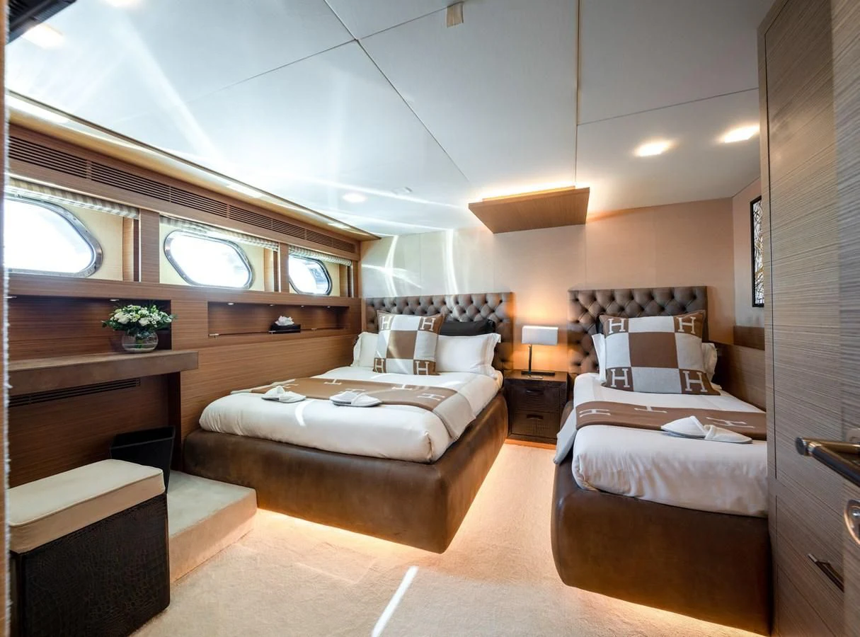 a bedroom with a bed and a desk aboard QHT Yacht for Sale