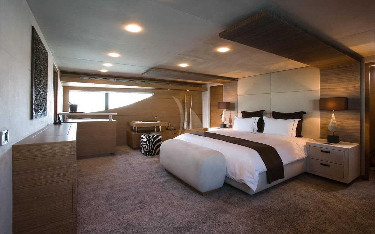 a large bedroom with a large bed aboard QHT Yacht for Sale