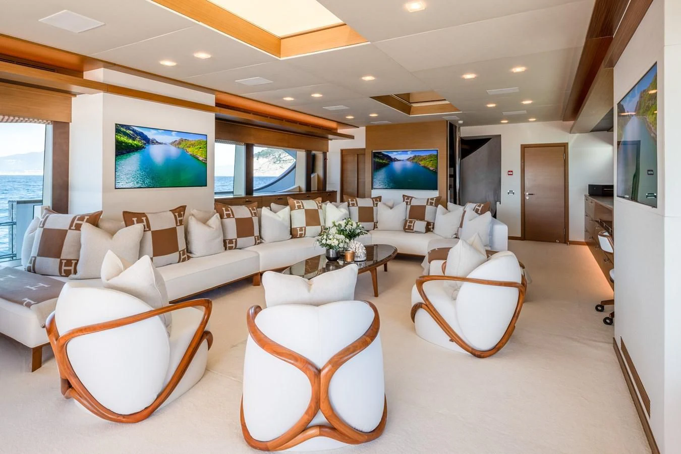 a living room with a large screen aboard QHT Yacht for Sale