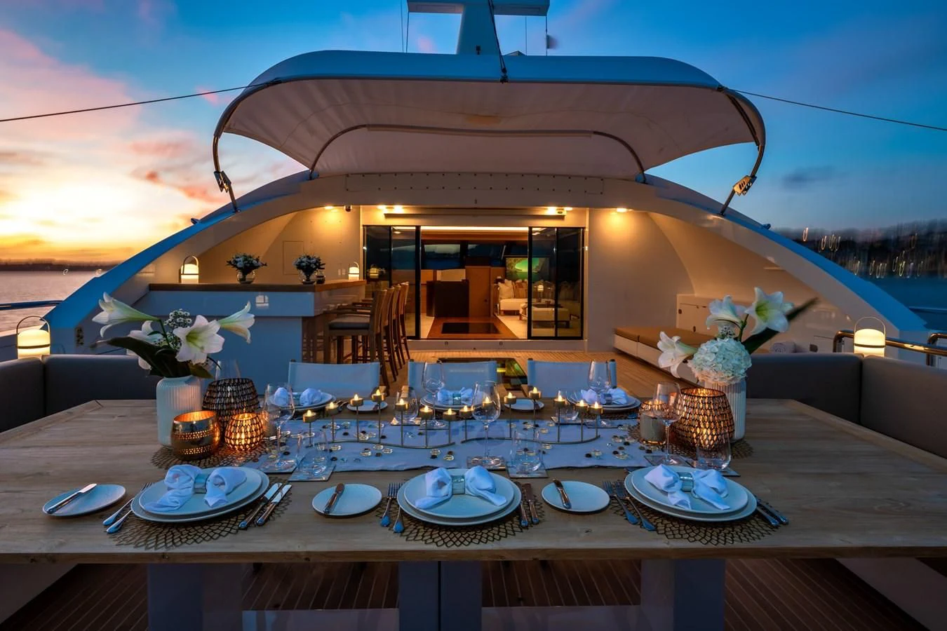 a table with plates and glasses on it aboard QHT Yacht for Sale