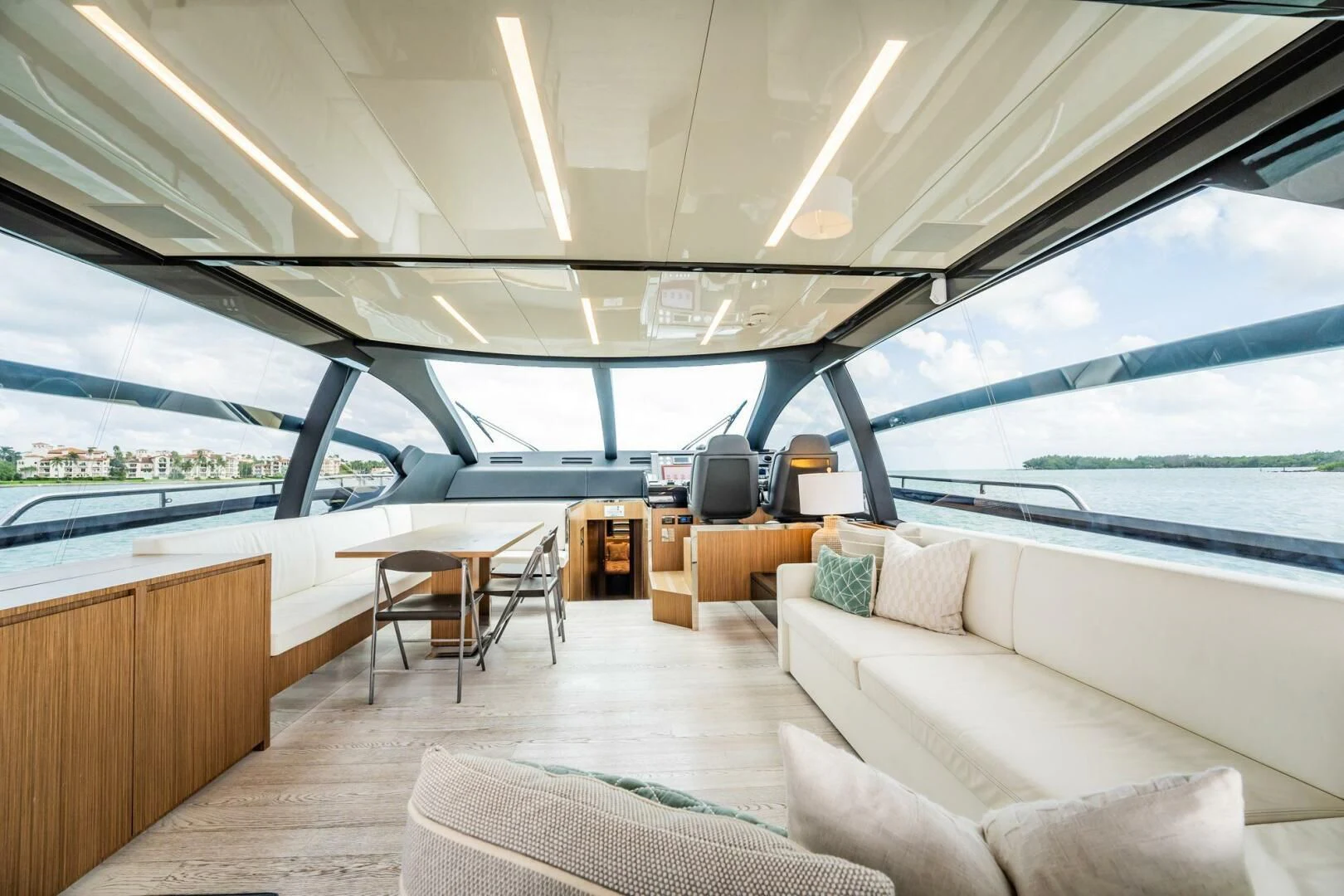 a room with a couch and a table and a large window aboard RECREATIONAL USE Yacht for Sale