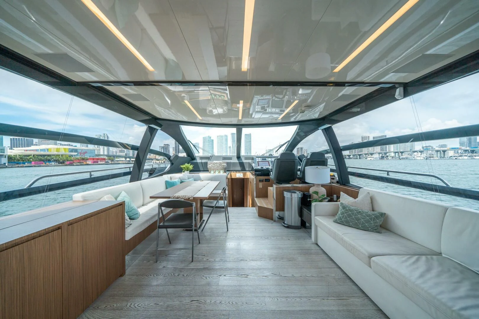 a room with a couch and a table and a large window aboard RECREATIONAL USE Yacht for Sale