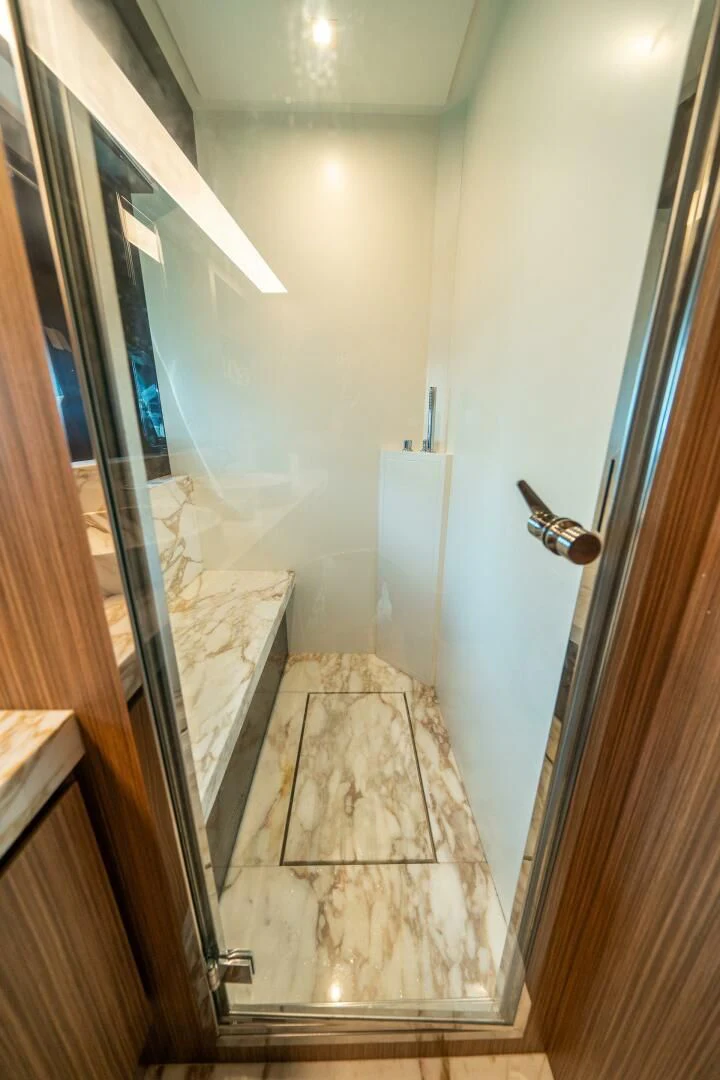 a bathroom with a glass door aboard RECREATIONAL USE Yacht for Sale