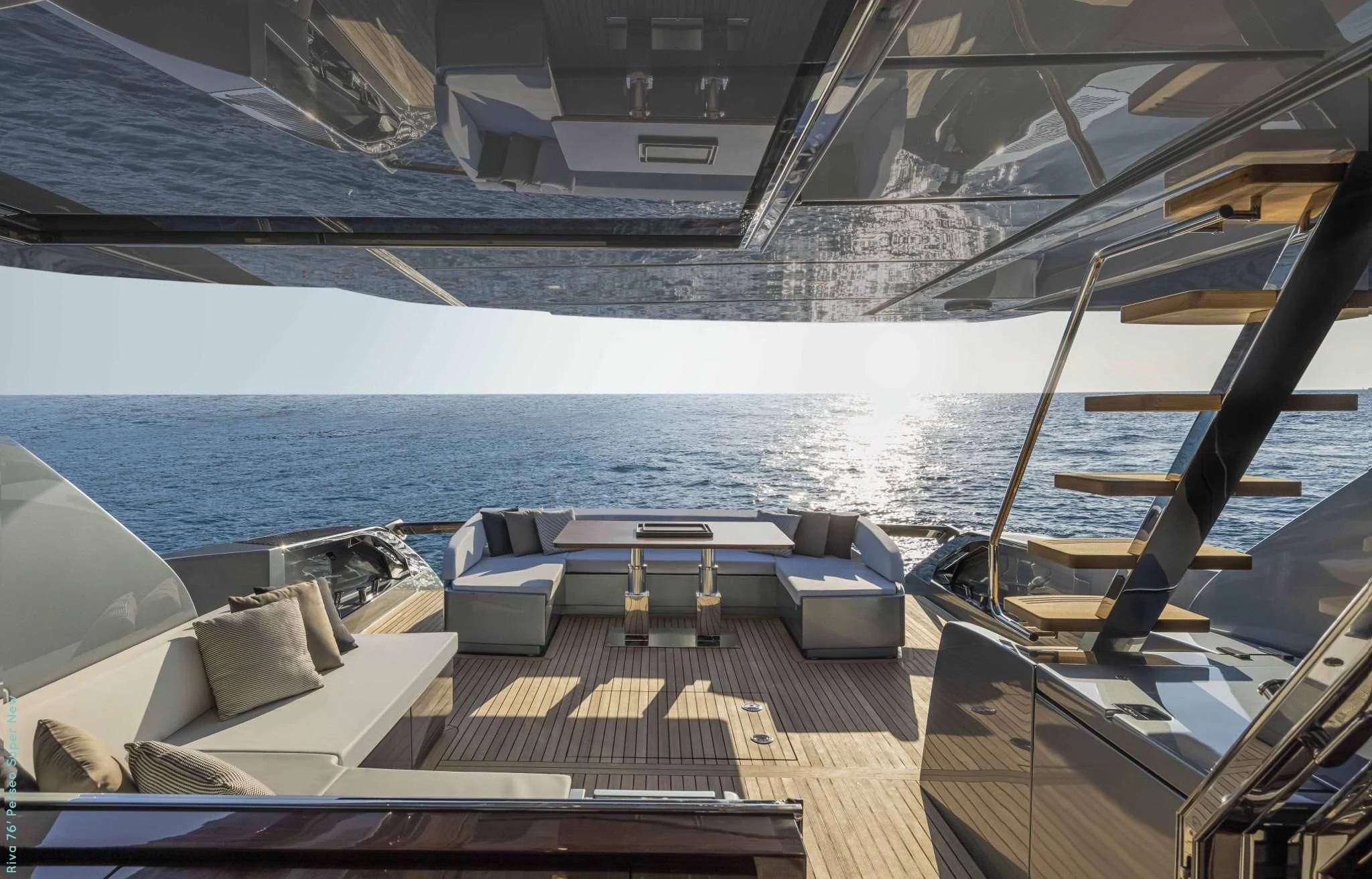 a deck with chairs and a body of water in the background aboard RECREATIONAL USE Yacht for Sale
