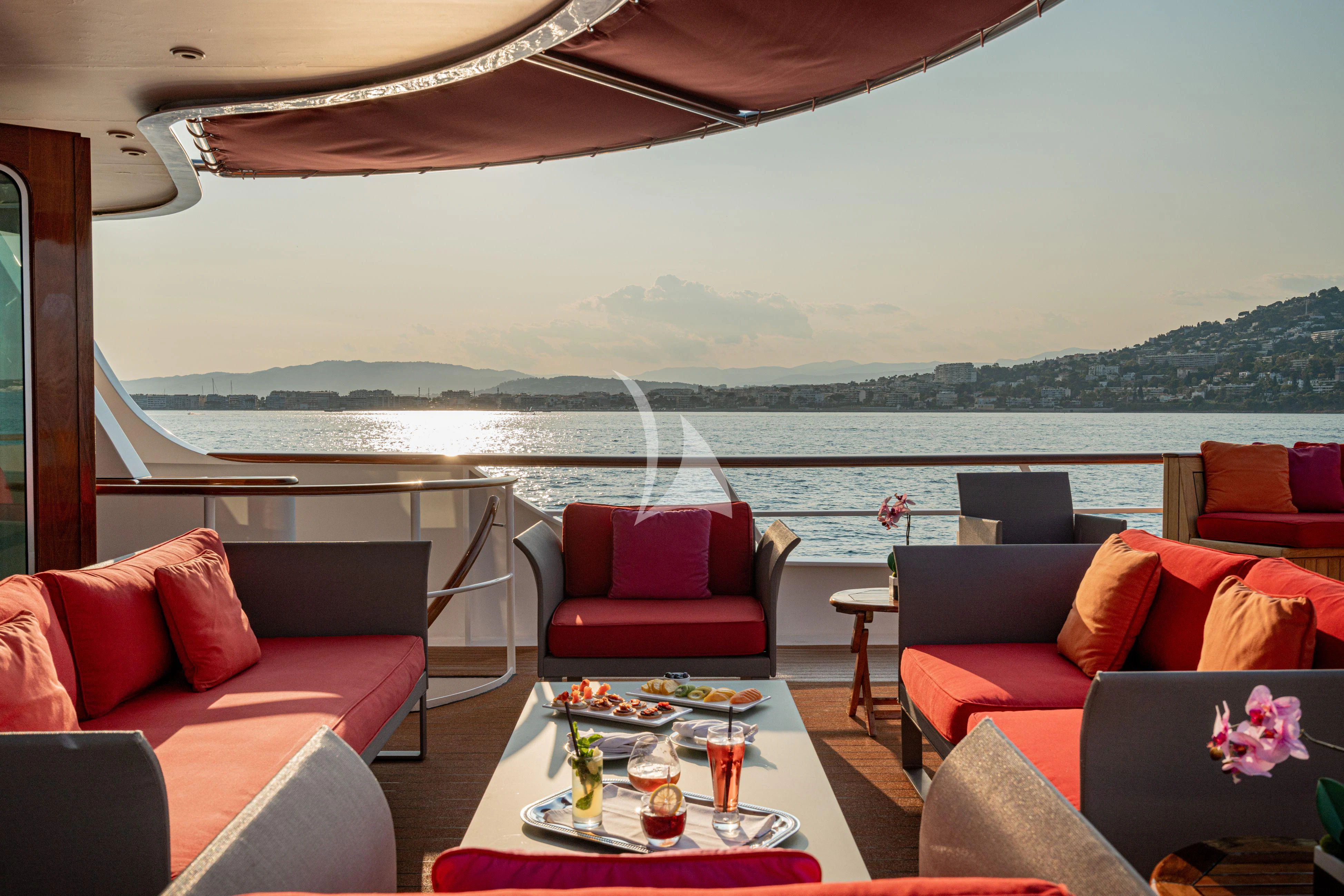 a room with couches and a table and a view of the ocean aboard SEA LION Yacht for Sale