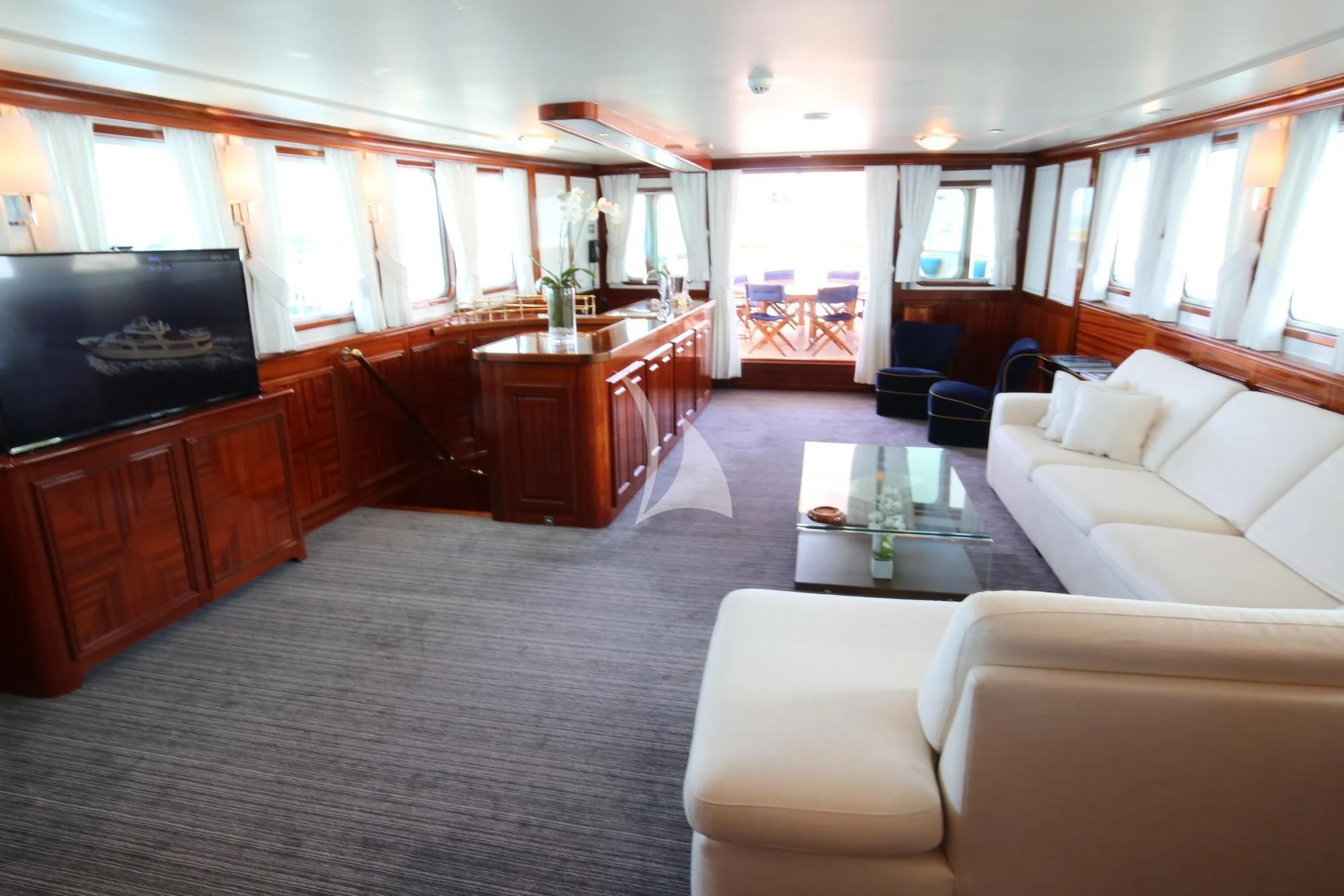 a large living room with a piano aboard SEA LION Yacht for Sale