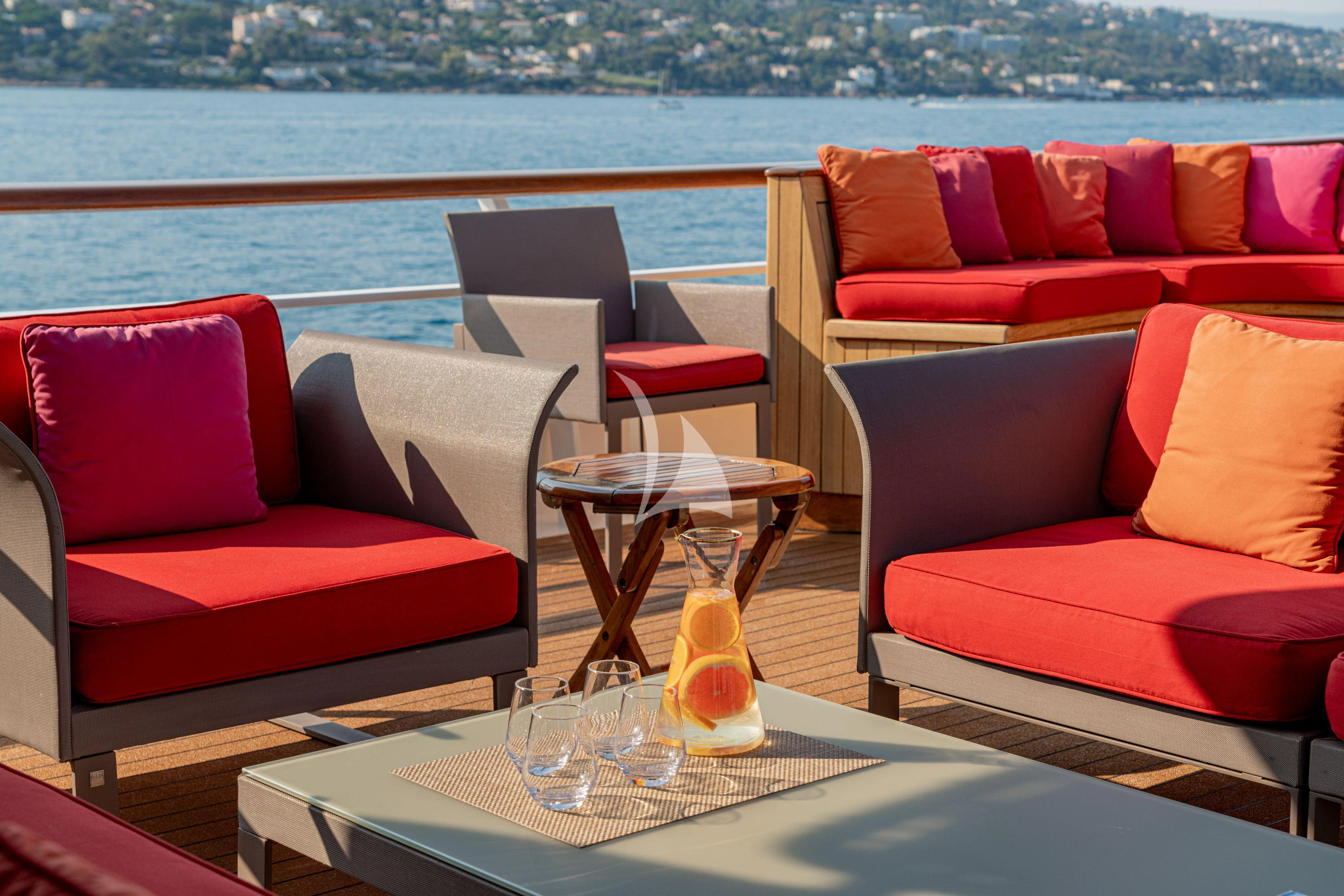 a table with chairs and a vase on it aboard SEA LION Yacht for Sale