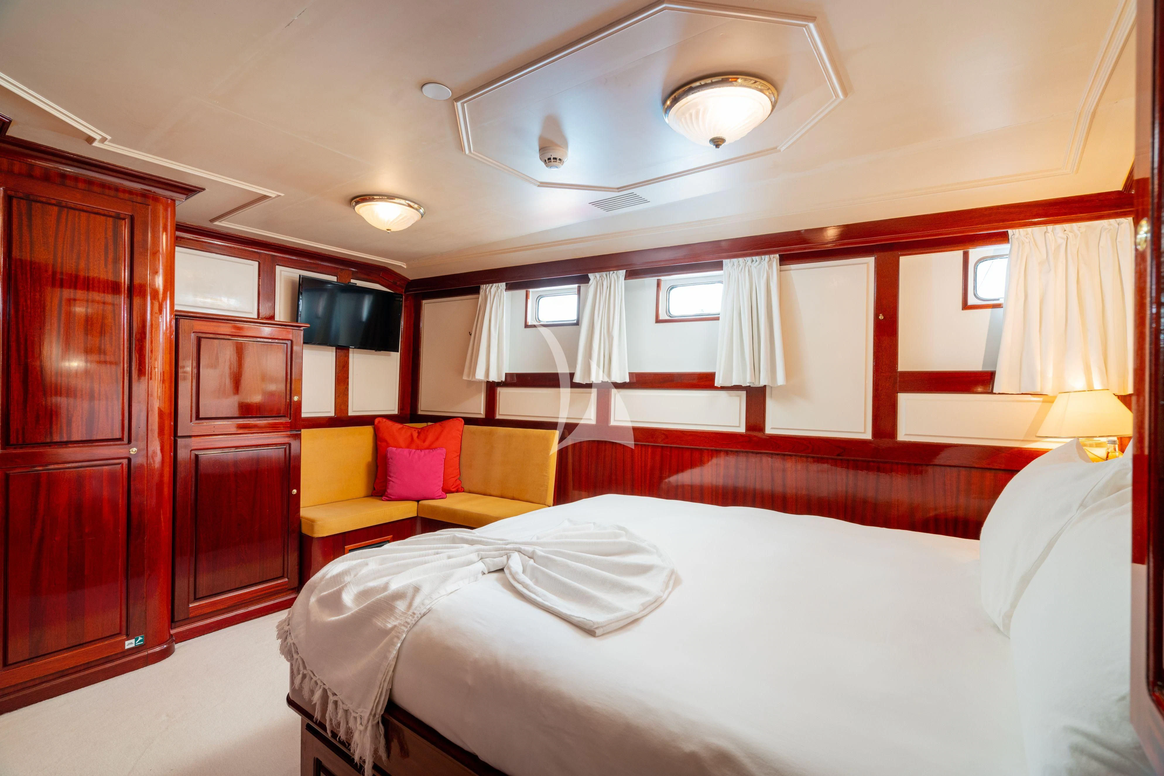 a room with a bed and a couch aboard SEA LION Yacht for Sale