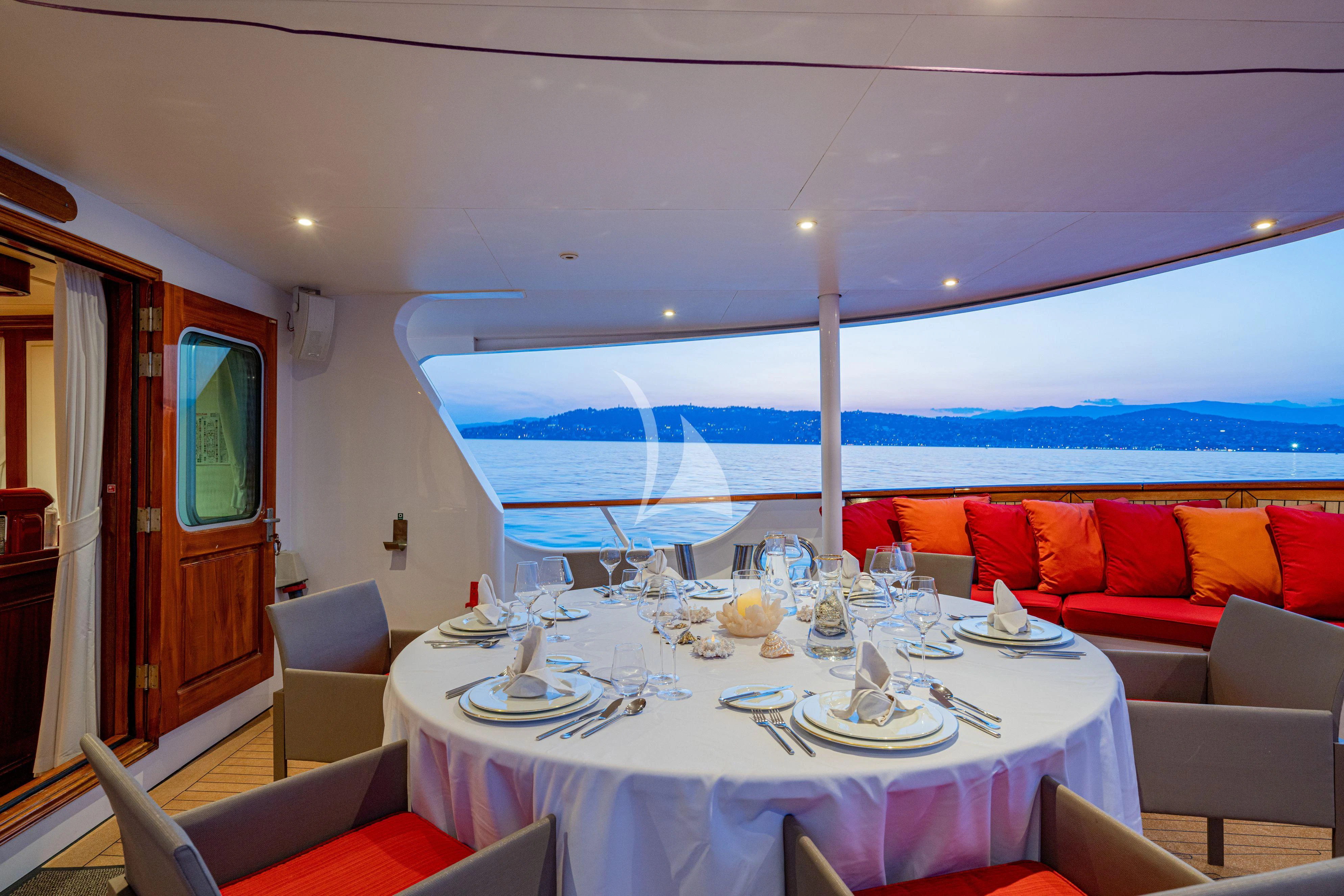 a dining table set for a dinner aboard SEA LION Yacht for Sale