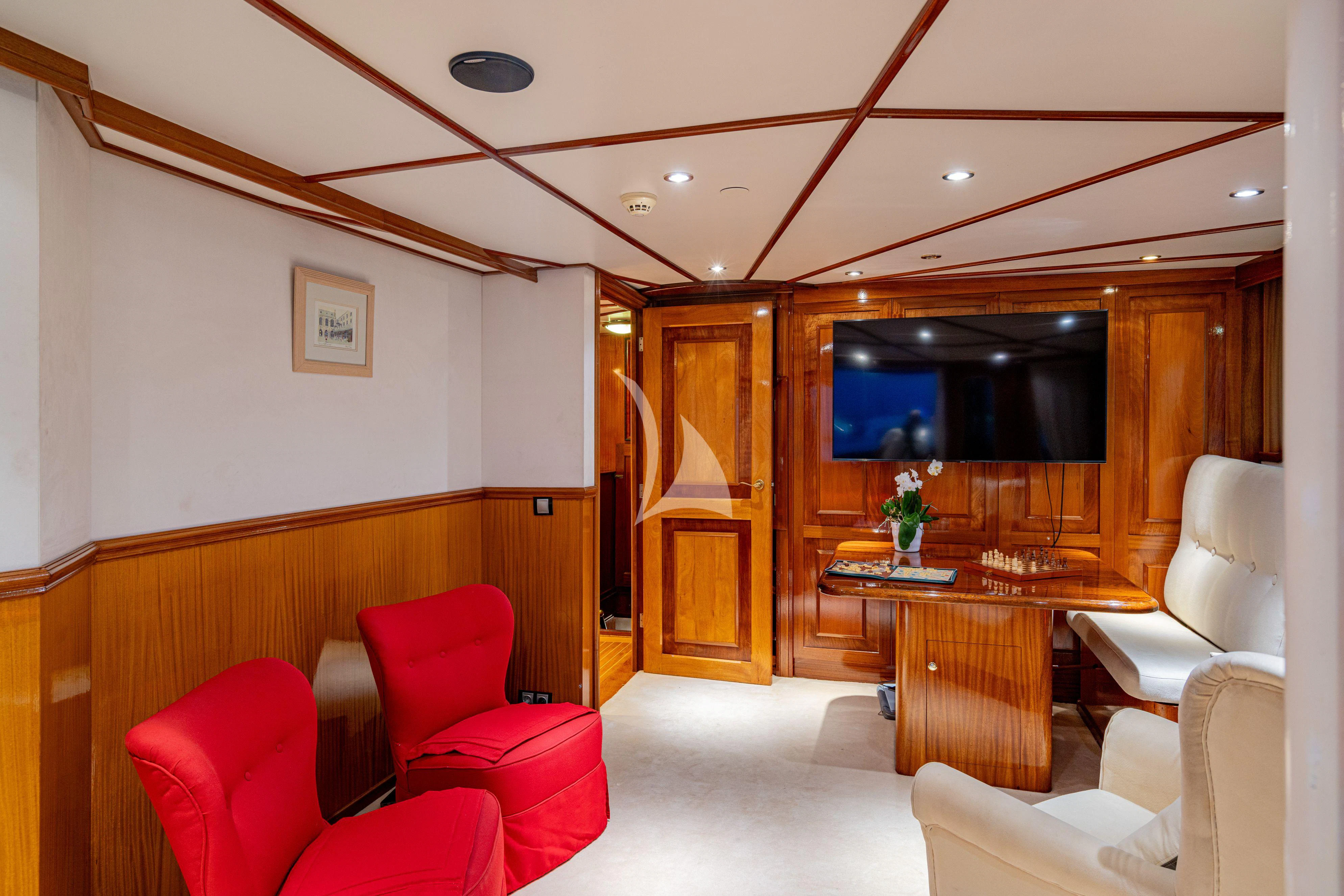 a room with chairs and a table aboard SEA LION Yacht for Sale