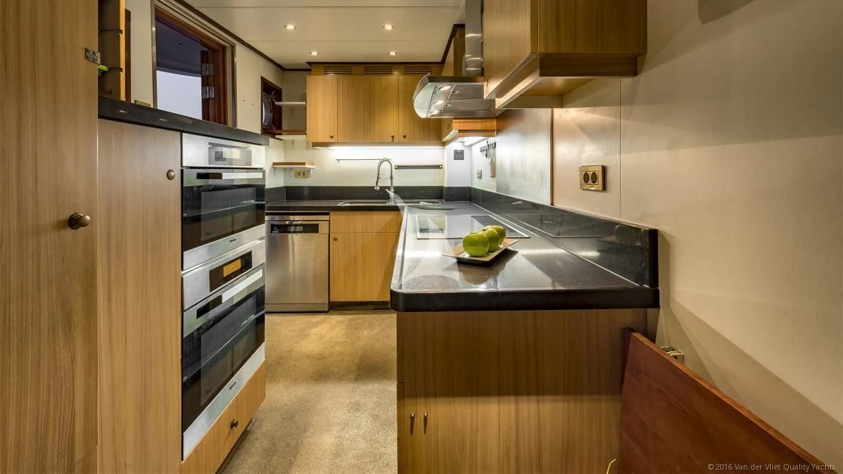 a kitchen with wooden cabinets aboard SEA LION Yacht for Sale