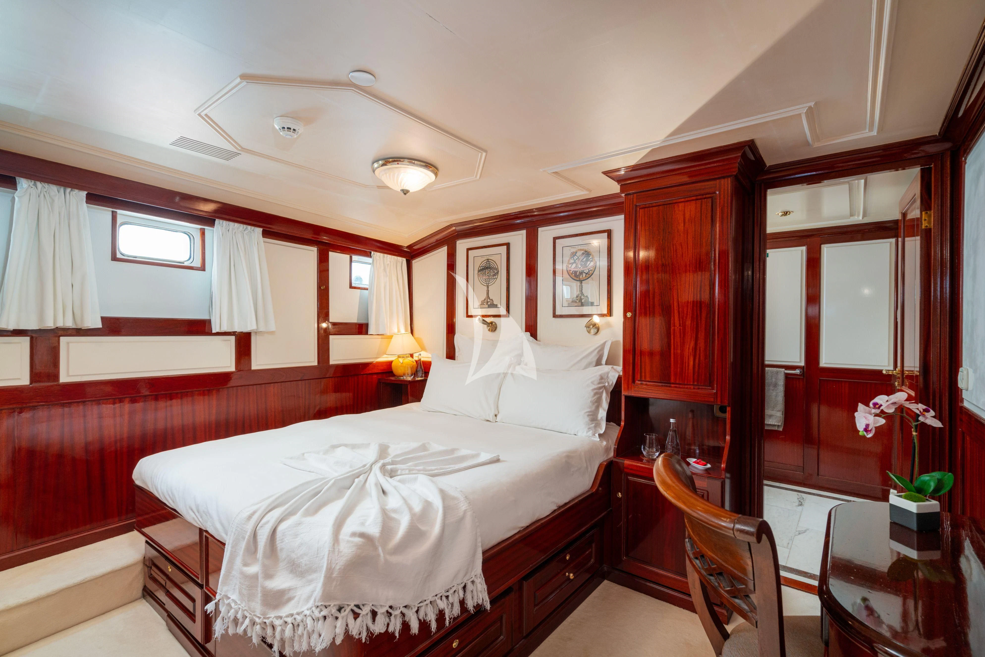 a bedroom with a bed and a desk aboard SEA LION Yacht for Sale