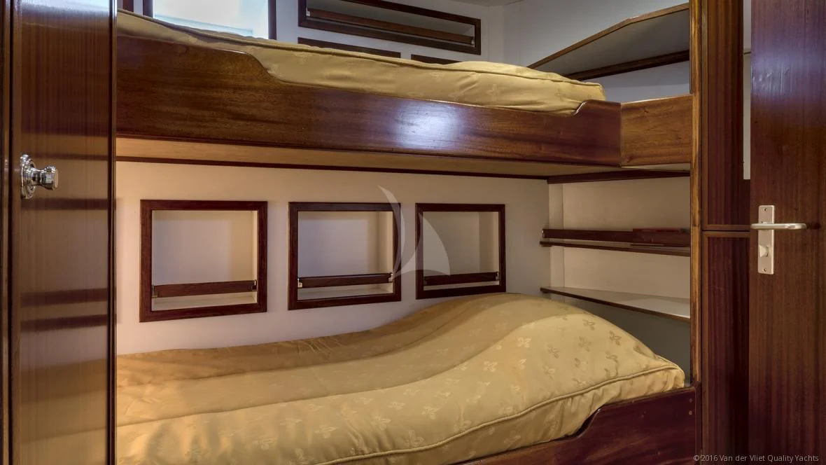 a bed with a wooden frame aboard SEA LION Yacht for Sale