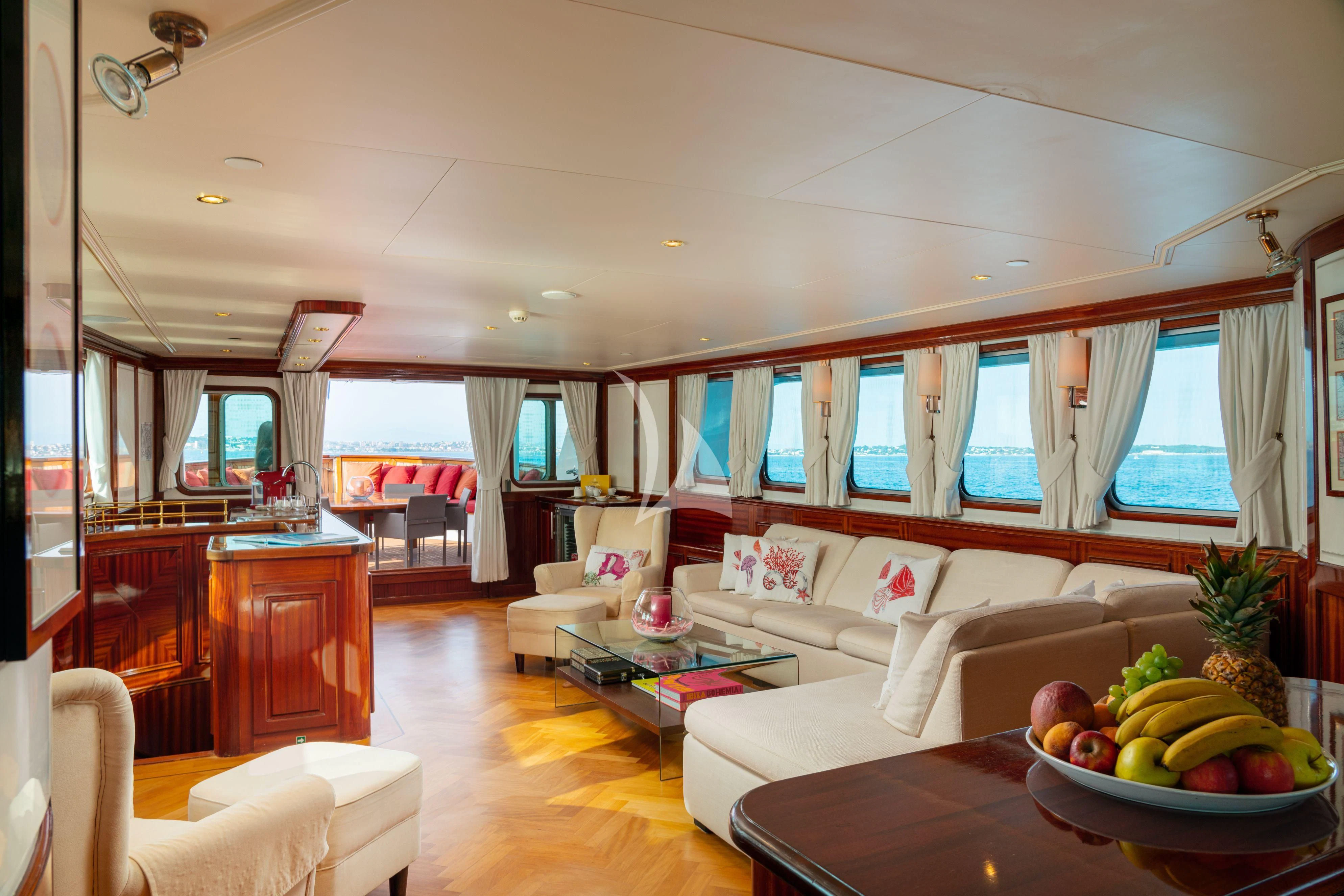 a living room with a couch and a table with fruit on it aboard SEA LION Yacht for Sale