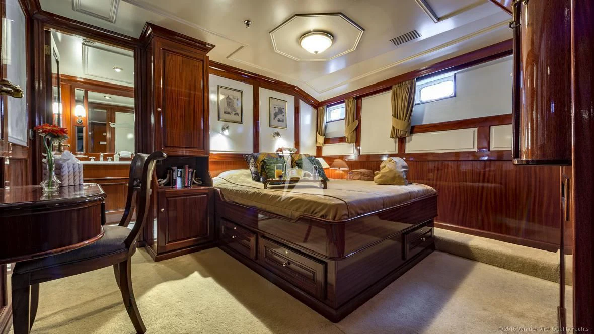a bedroom with a bed and a desk aboard SEA LION Yacht for Sale