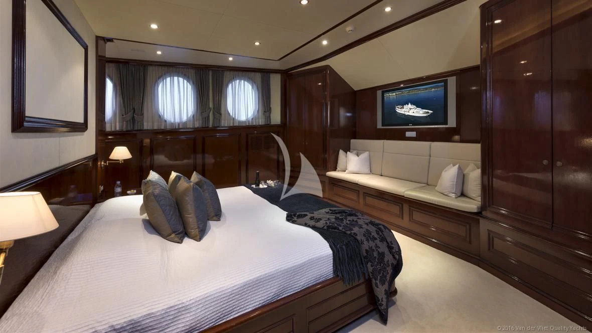 a room with a bed and a television aboard SEA LION Yacht for Sale