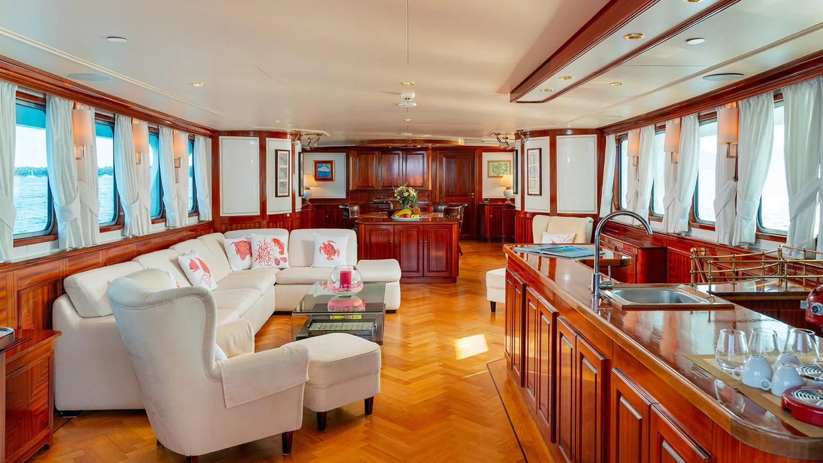 a living room with a kitchen and dining area aboard SEA LION Yacht for Sale