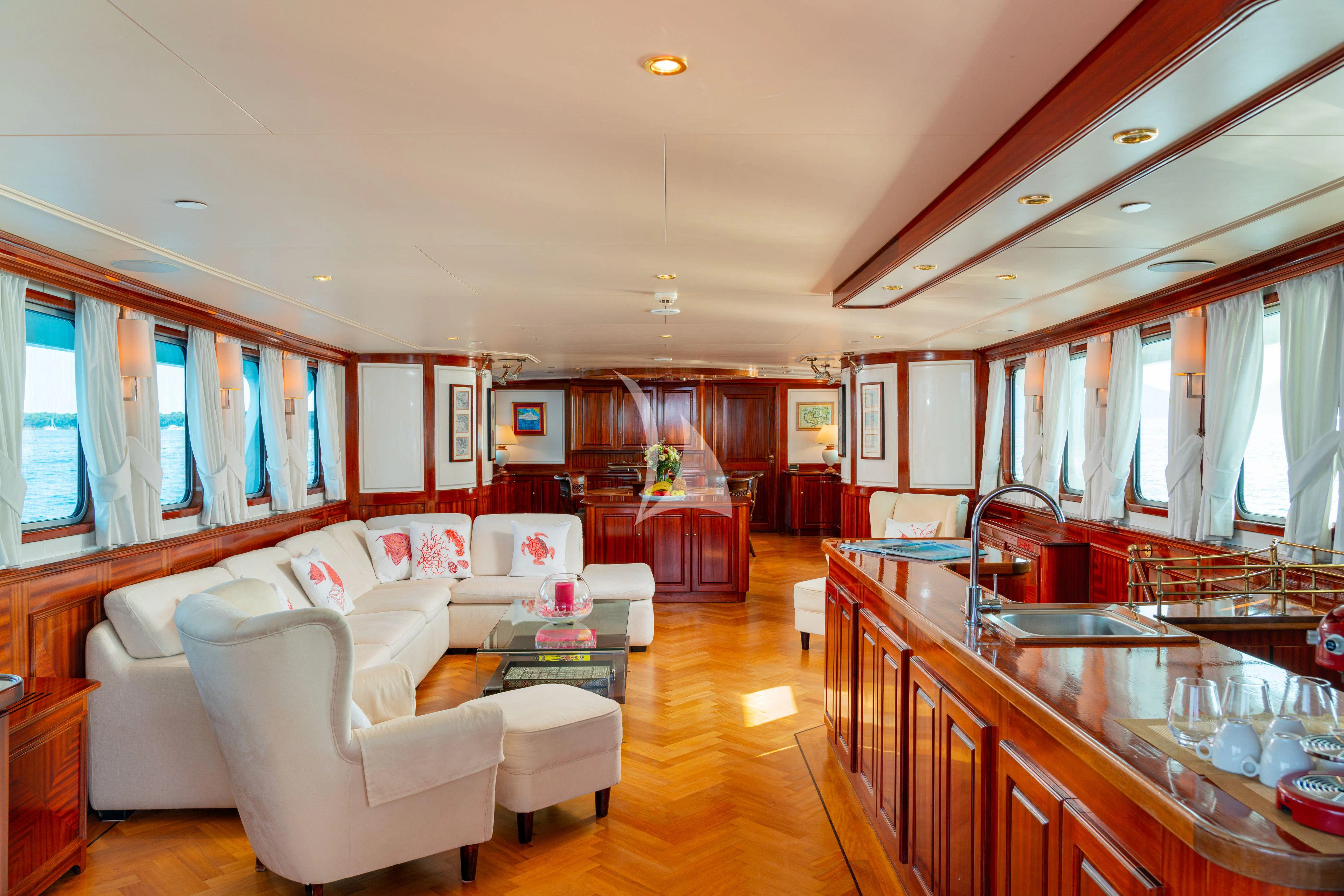 a living room with a kitchen and dining area aboard SEA LION Yacht for Sale