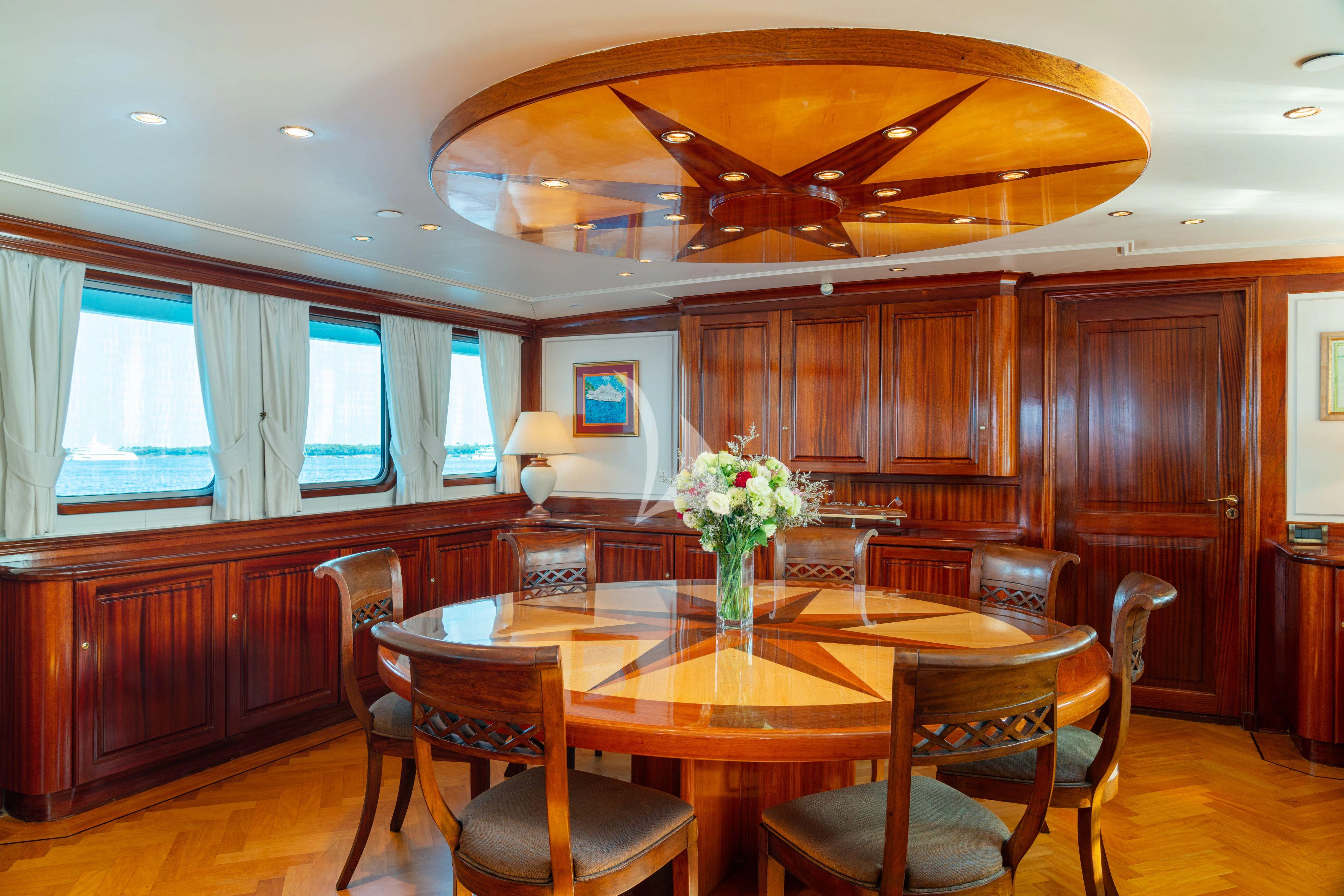 a dining room with a table and chairs aboard SEA LION Yacht for Sale