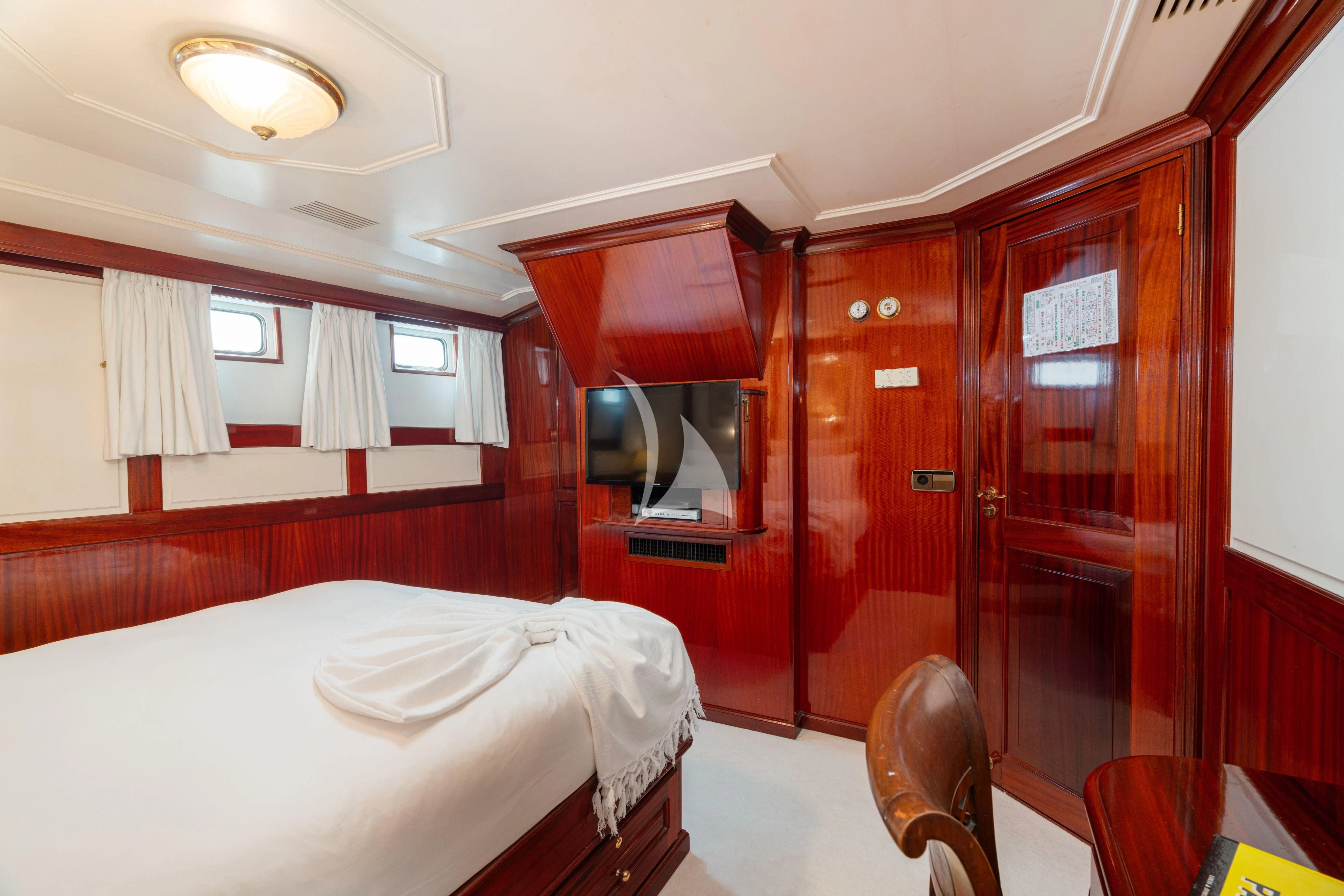 a room with a bed and a mirror aboard SEA LION Yacht for Sale