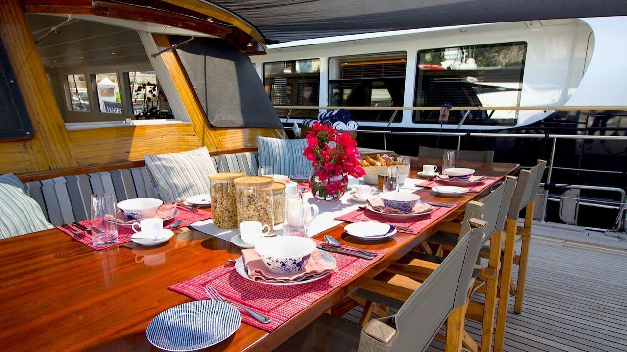 a table with plates and cups on it aboard VITA DOLCE Yacht for Sale