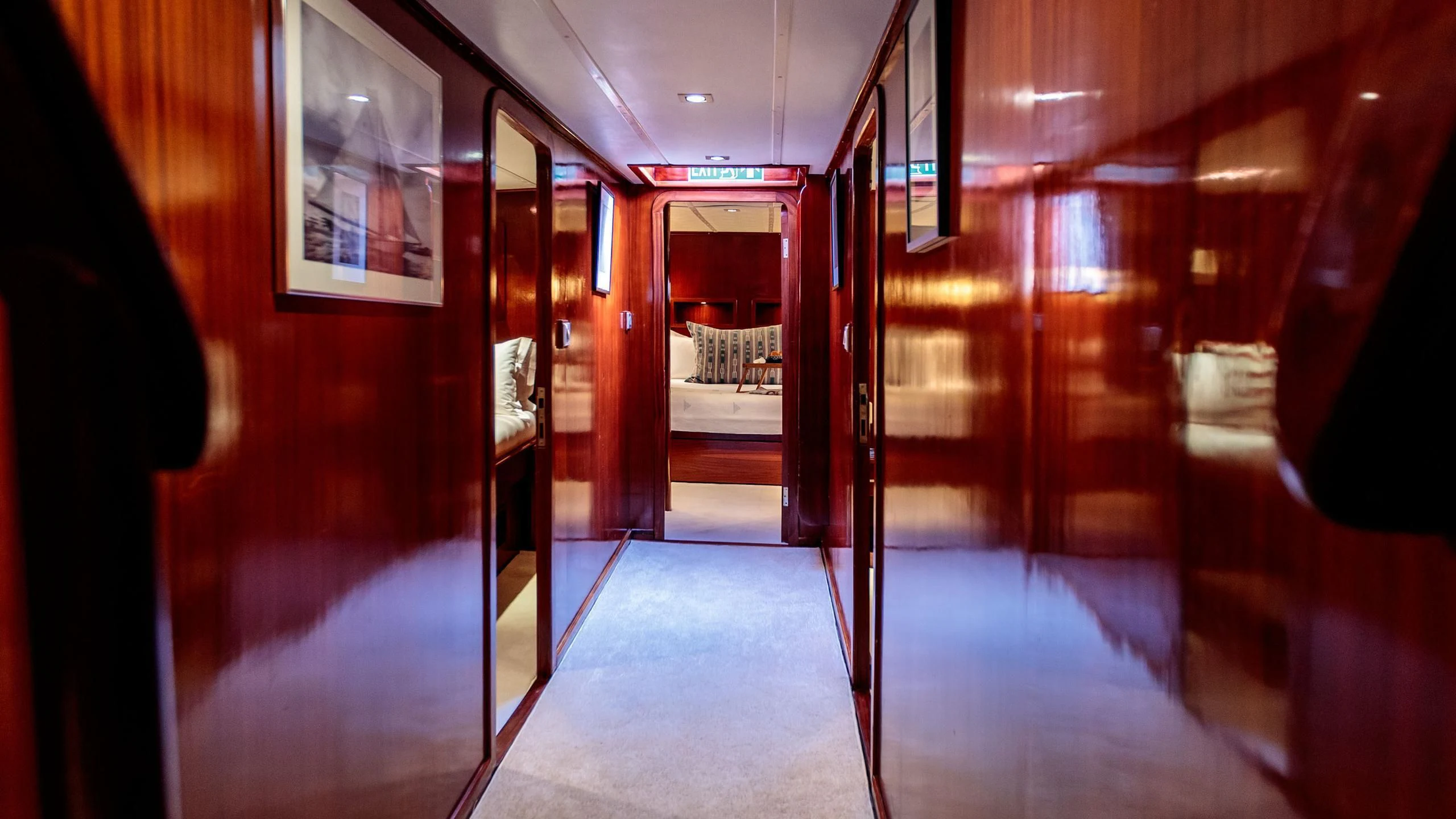 a hallway with red doors aboard VITA DOLCE Yacht for Sale