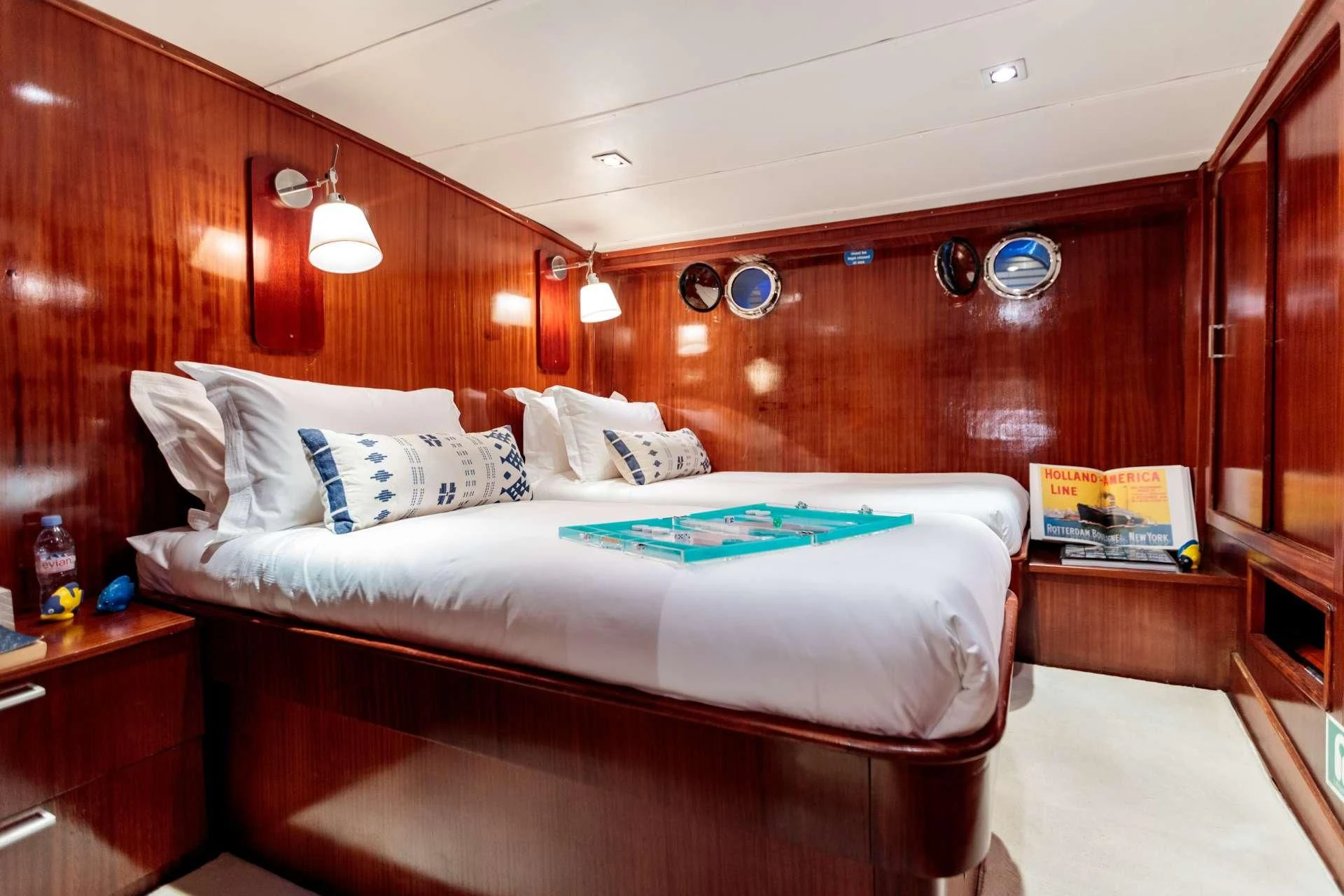 a bed with a wooden wall aboard VITA DOLCE Yacht for Sale