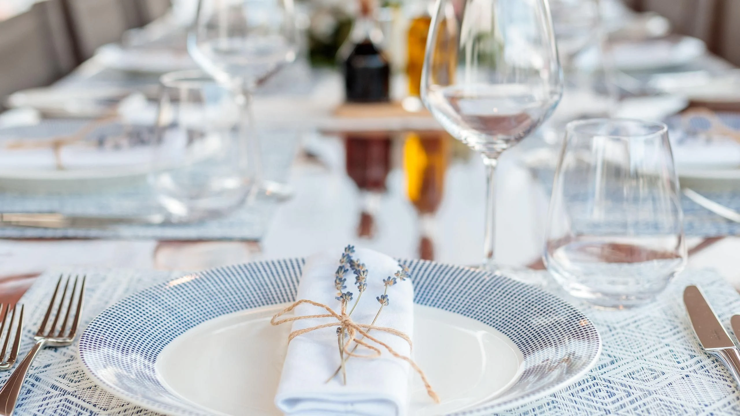 a table with plates and glasses aboard VITA DOLCE Yacht for Sale