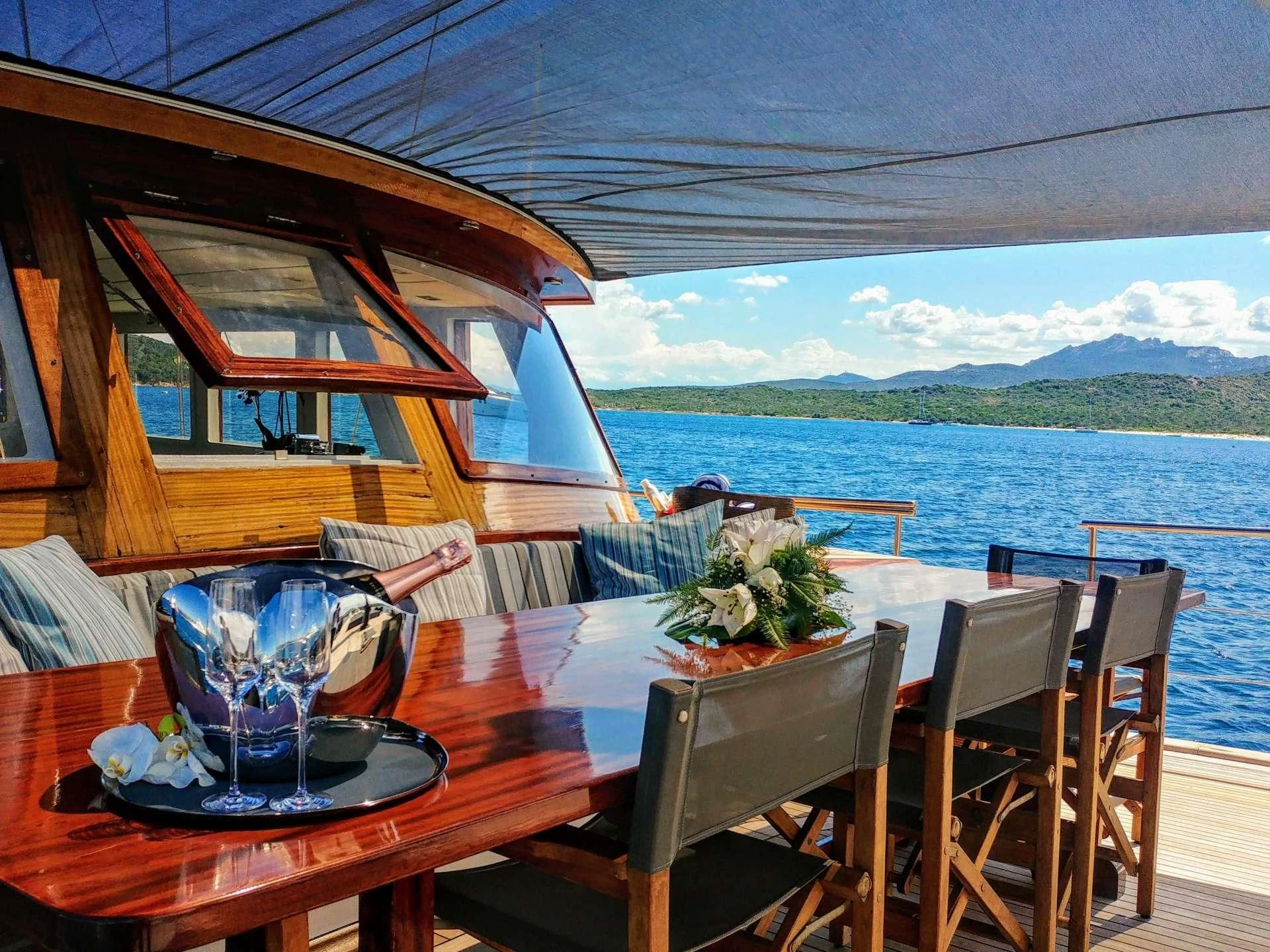 a table with a plate and a bowl of salad on it aboard VITA DOLCE Yacht for Sale