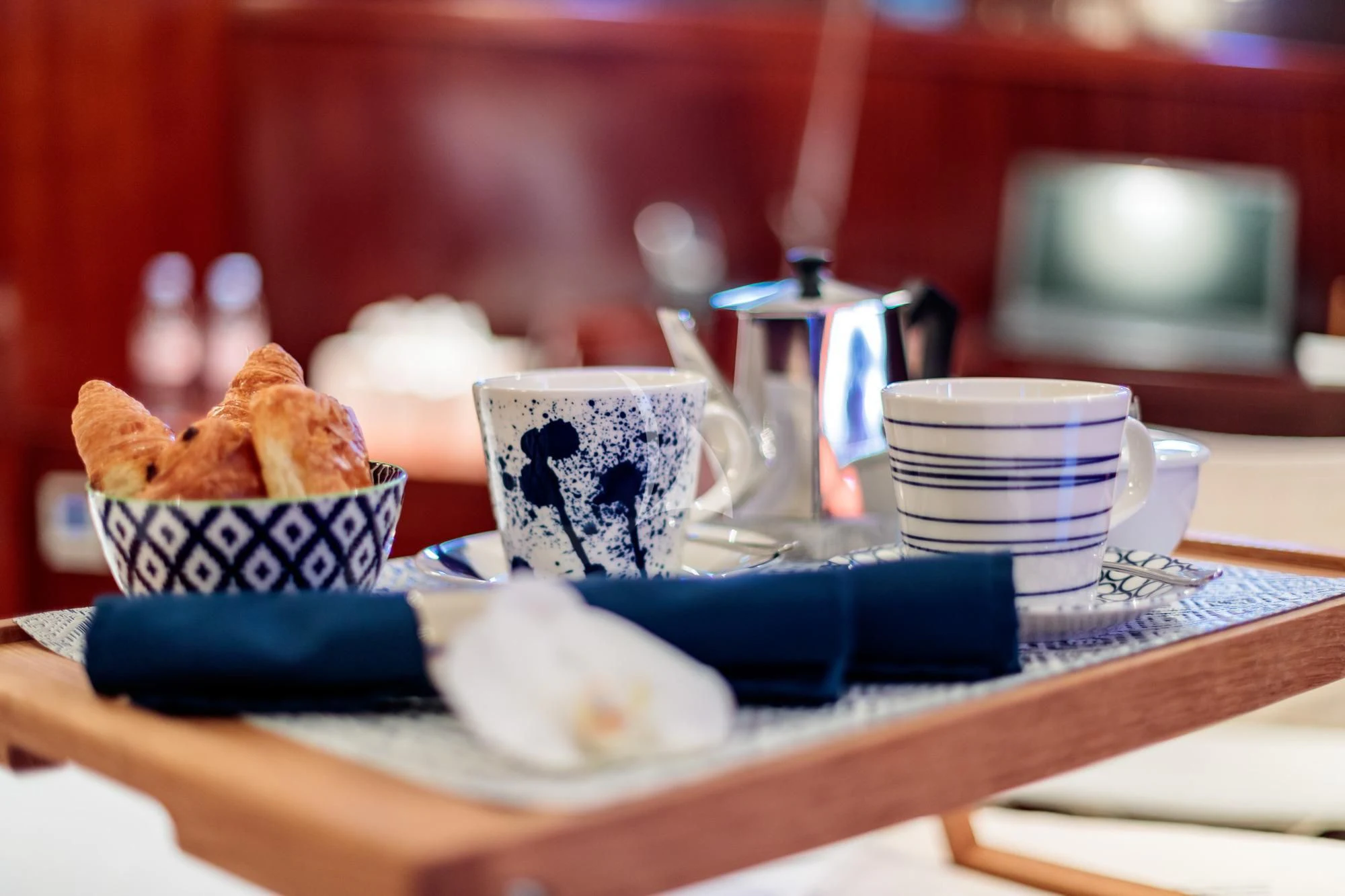 a table with a plate of food and a laptop on it aboard VITA DOLCE Yacht for Sale