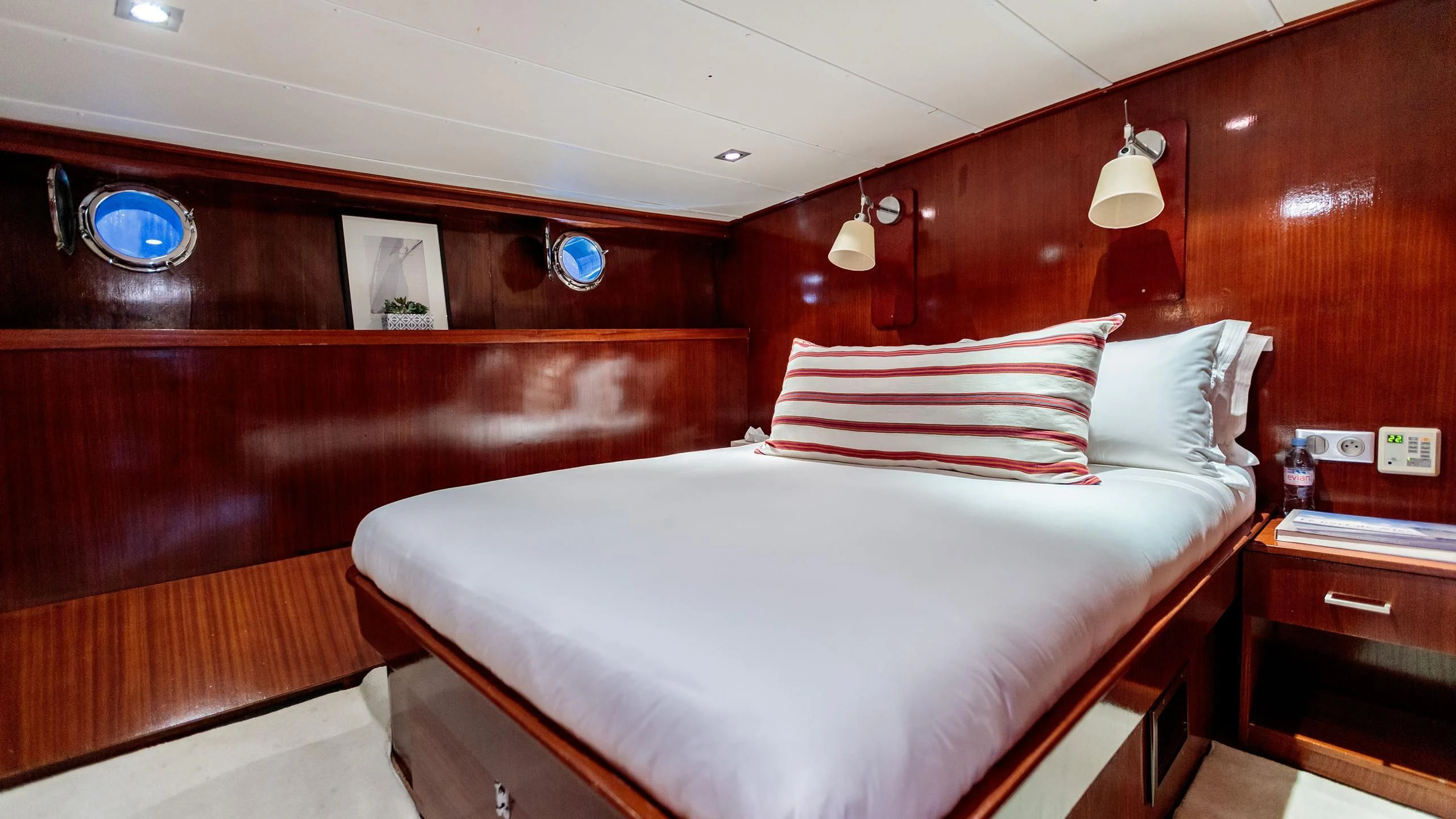 a bed with a white sheet and pillows on it aboard VITA DOLCE Yacht for Sale